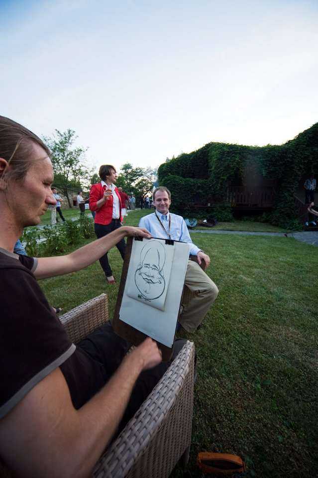Rysownik - karykaturzysta sporządza portrety uczestników Konferencji podczas biesiady grillowej